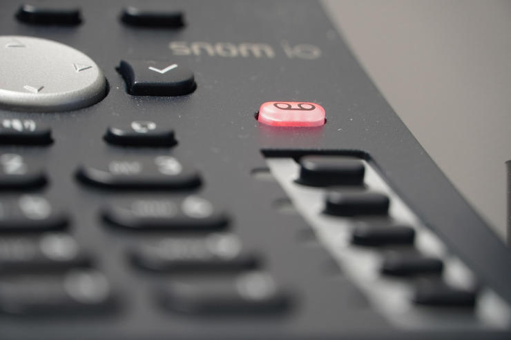 close up telephone voip machine with virtual icon of service provider of communication technology in the office desk operation station room for business and contact us concept